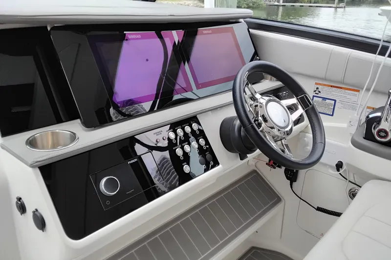 Slide: The Image of 2023 Sea Ray Sundancer 320 Outboard helm with modern controls and navigation displays. - 18