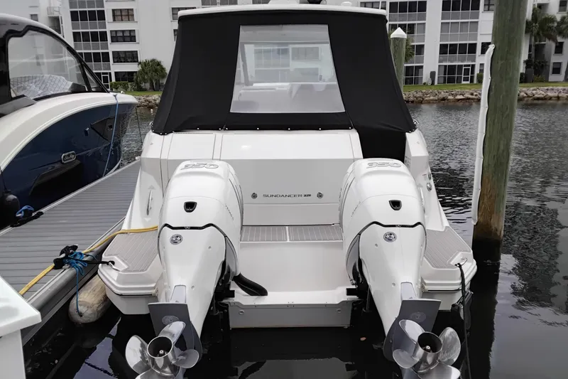 Slide: The Image of 2023 Sea Ray Sundancer 320 Outboard docked, showcasing dual engines and sleek design. - 3