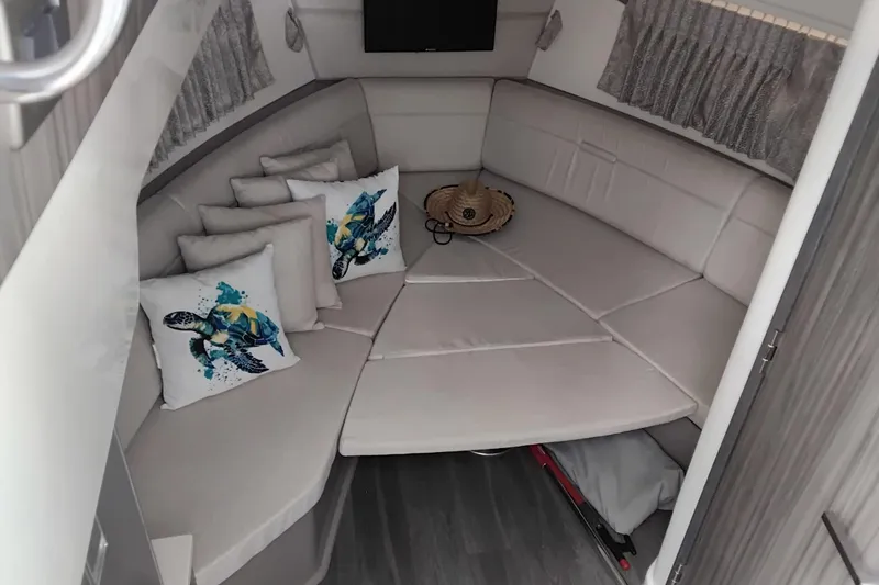 Slide: The Image of Luxurious interior of 2023 Sea Ray Sundancer 320 Outboard with plush seating and decorative pillows. - 33