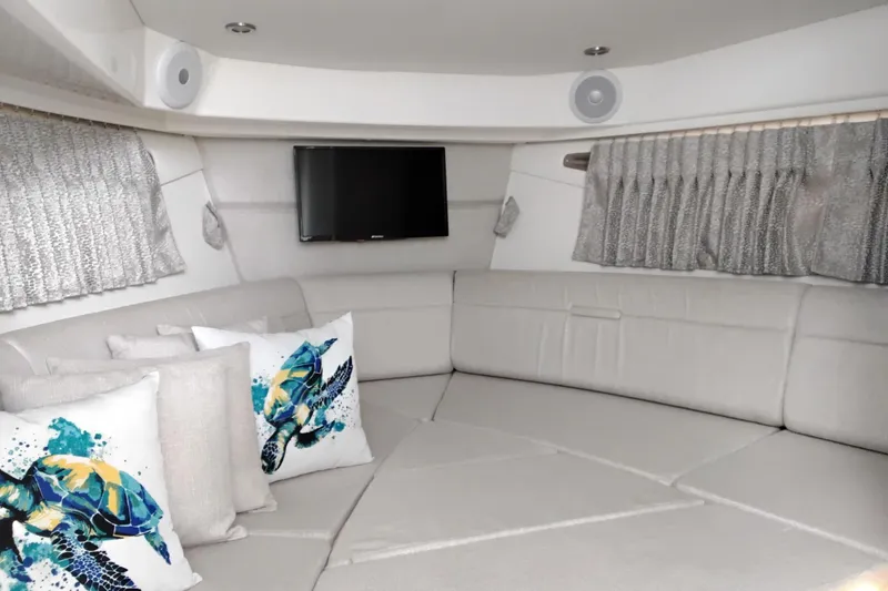 Slide: The Image of Luxurious interior of 2023 Sea Ray Sundancer 320 Outboard with plush seating and decorative pillows. - 26