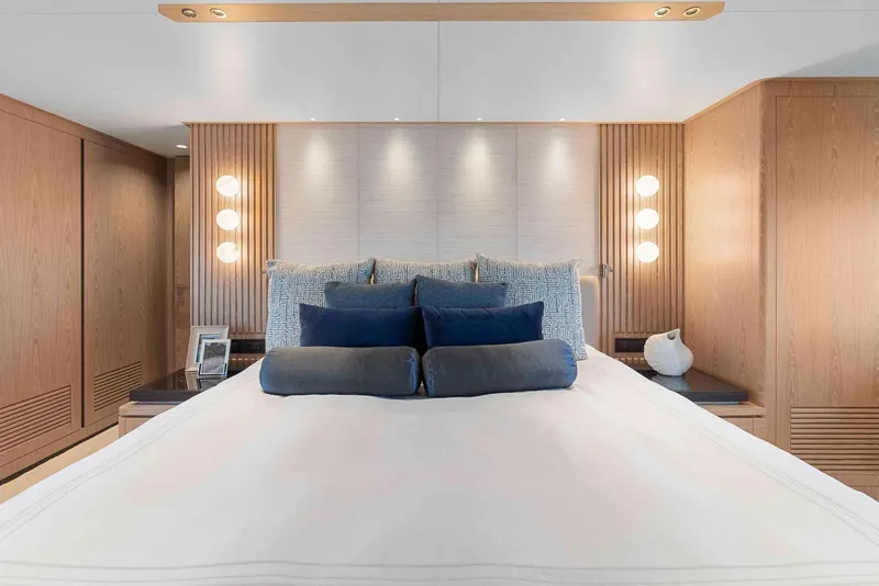 Slide: The Image of Luxurious bedroom interior on Horizon FD100 yacht, featuring elegant wood paneling and modern lighting. - 16