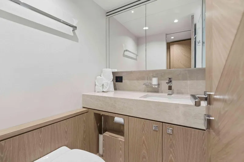 Slide: The Image of Modern bathroom interior on Horizon FD100 yacht, featuring sleek design and wooden cabinetry, 2026 model. - 15