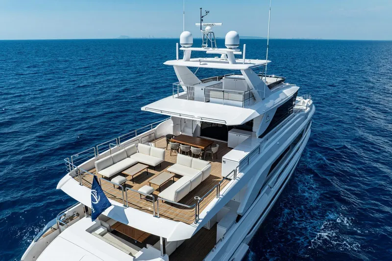 Slide: The Image of Luxurious 2026 Horizon FD100 yacht cruising on open sea, featuring spacious deck and seating. - 1
