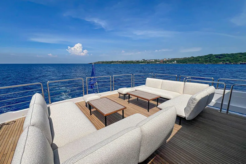Slide: The Image of Luxurious 2026 Horizon FD100 yacht deck with elegant seating, overlooking serene ocean views. - 42