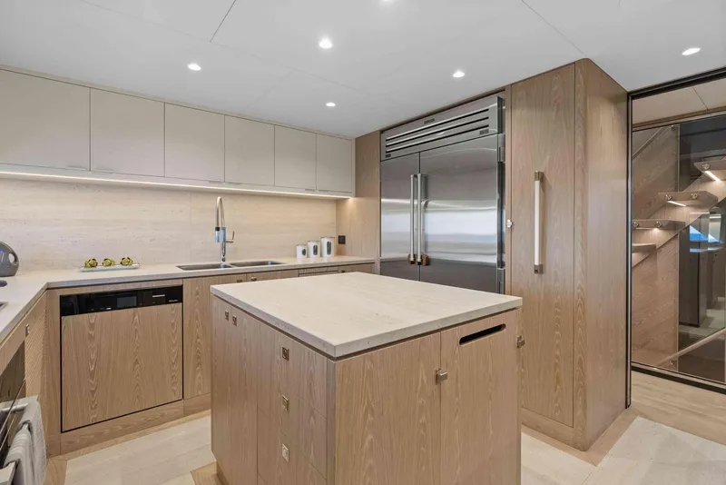 Slide: The Image of Modern kitchen interior on Horizon FD100 yacht, featuring sleek cabinetry and stainless steel appliances, 2026 model. - 14