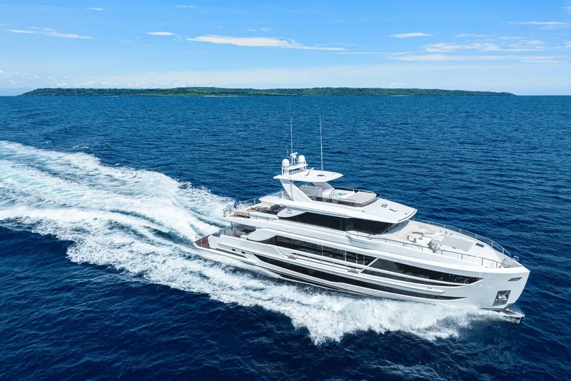 Slide: The Image of Luxurious 2026 Horizon FD100 yacht cruising on open blue sea near a distant island. - 45