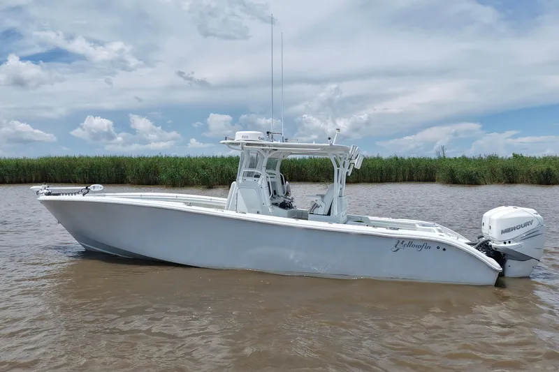 Slide: The Image of 2016 Yellowfin 32 Offshore boat on calm water, clear sky background. - 5