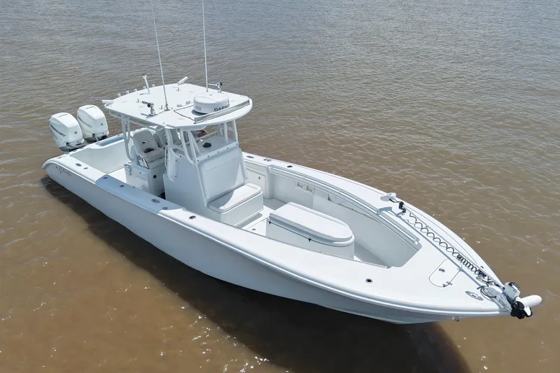 Slide: The Image of 2016 Yellowfin 32 Offshore boat on calm water, featuring dual outboard motors. - 19