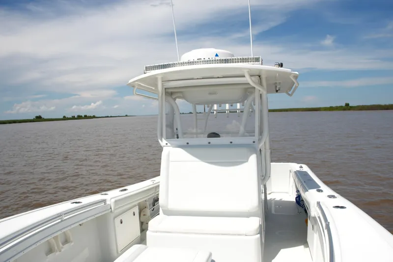 Slide: The Image of 2016 Yellowfin 32 Offshore boat on calm water under a clear sky. - 23