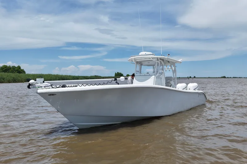 Slide: The Image of 2016 Yellowfin 32 Offshore boat on calm water under a clear sky. - 8