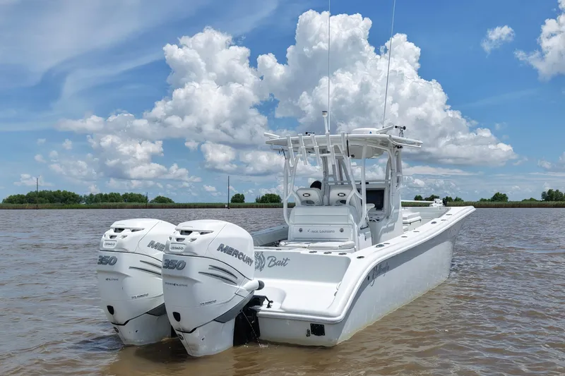 Slide: The Image of 2016 Yellowfin 32 Offshore boat with twin Mercury 350 engines on a sunny day. - 13