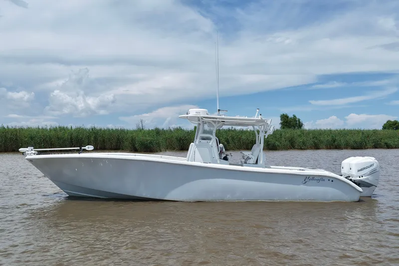 The Image of 2016 Yellowfin 32 Offshore boat on calm water with cloudy sky backdrop. - 0