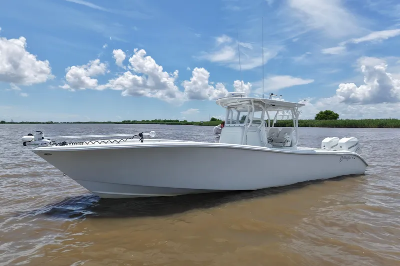Slide: The Image of 2016 Yellowfin 32 Offshore boat on calm water under a blue sky. - 9
