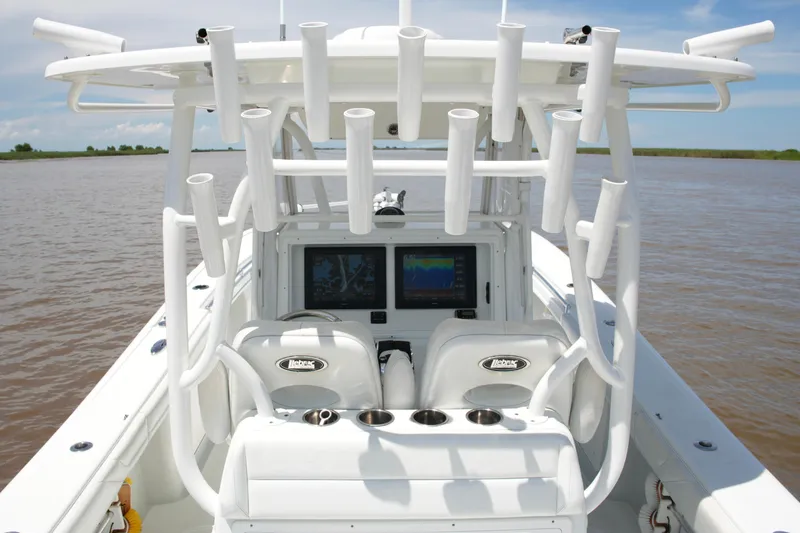 Slide: The Image of 2016 Yellowfin 32 Offshore boat interior with rod holders and navigation screens. - 34