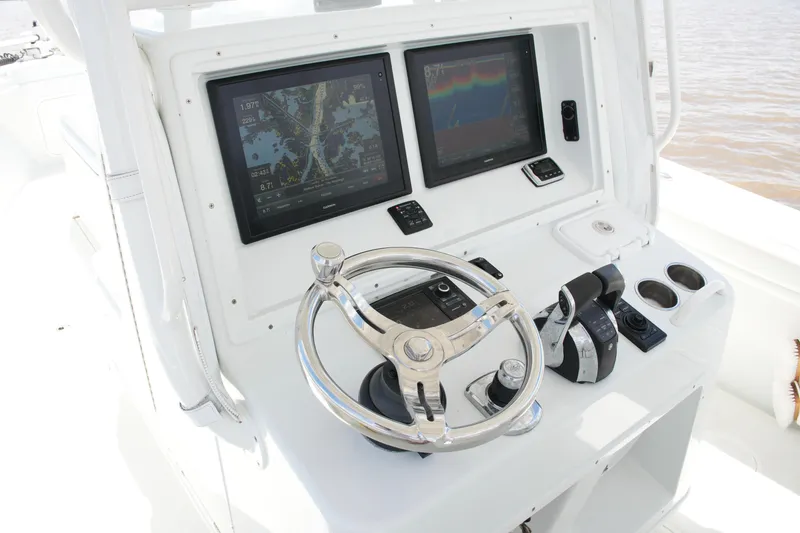 Slide: The Image of 2016 Yellowfin 32 Offshore boat helm with dual displays and steering wheel. - 31