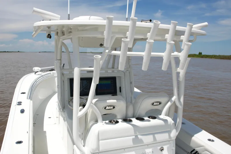 Slide: The Image of 2016 Yellowfin 32 Offshore boat with rod holders and navigation equipment on open water. - 32