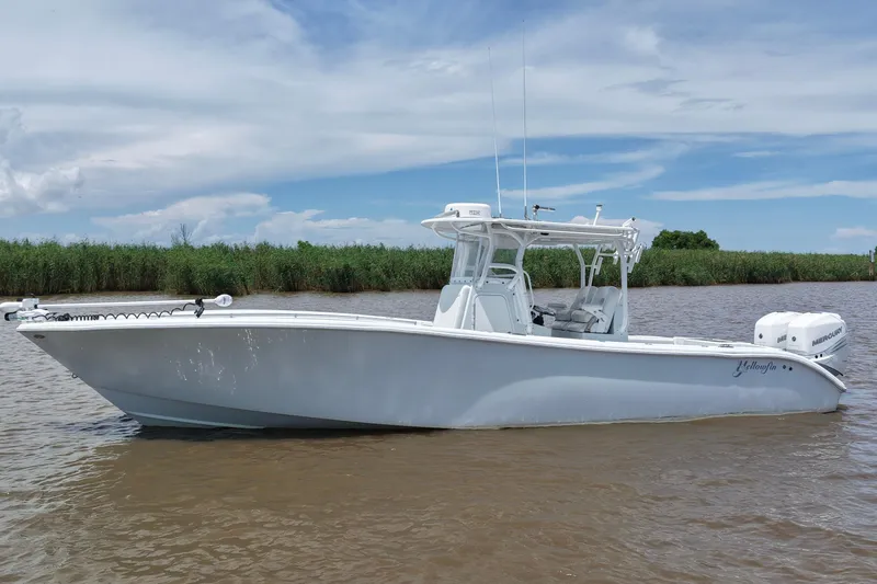 Slide: The Image of 2016 Yellowfin 32 Offshore boat on calm water with clear sky background. - 2