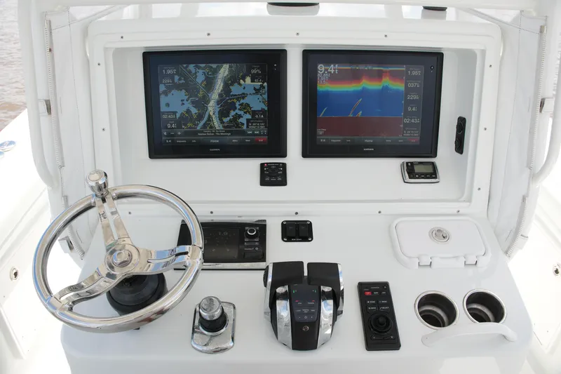 Slide: The Image of 2016 Yellowfin 32 Offshore boat dashboard with dual Garmin displays and controls. - 30