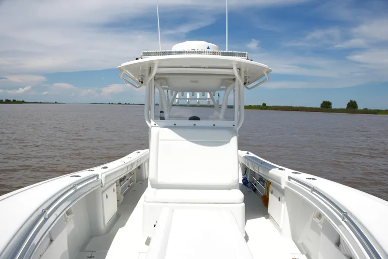 Slide: The Image of 2016 Yellowfin 32 Offshore boat on calm water under a clear sky. - 22