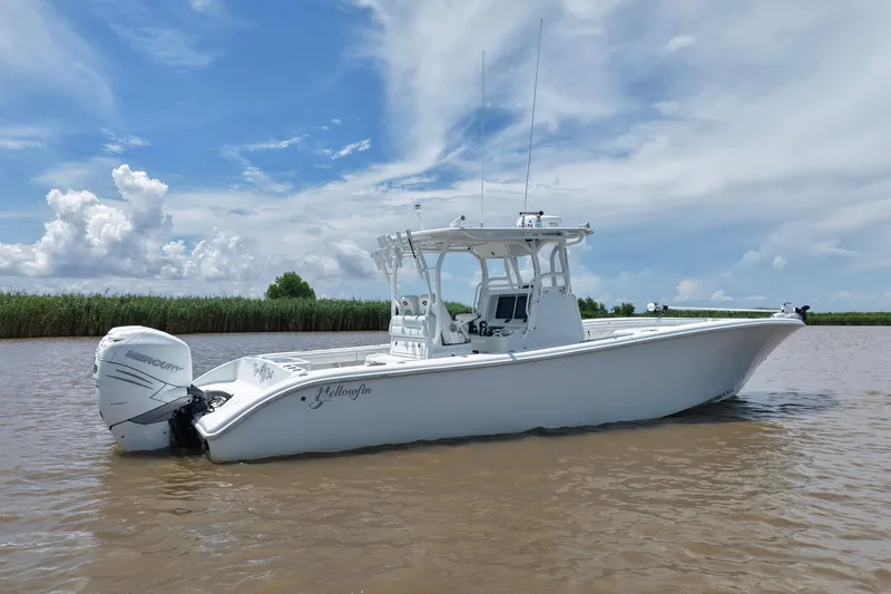 Slide: The Image of 2016 Yellowfin 32 Offshore boat on calm water under a blue sky. - 15
