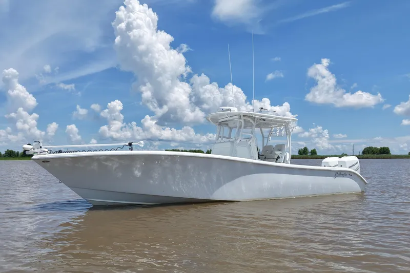 Slide: The Image of 2016 Yellowfin 32 Offshore boat on calm water under a blue sky with clouds. - 3