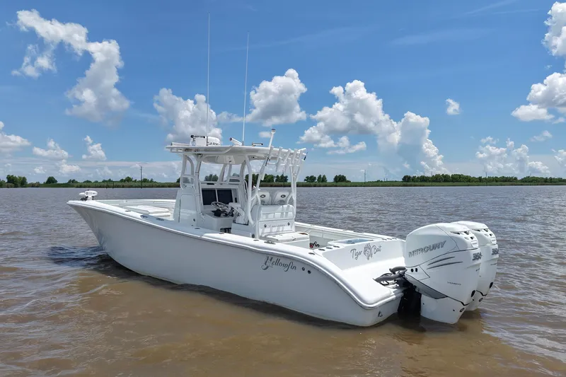 Slide: The Image of 2016 Yellowfin 32 Offshore boat on calm water under a blue sky. - 10