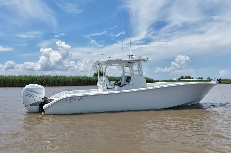 Slide: The Image of 2016 Yellowfin 32 Offshore boat on calm water under a blue sky. - 16
