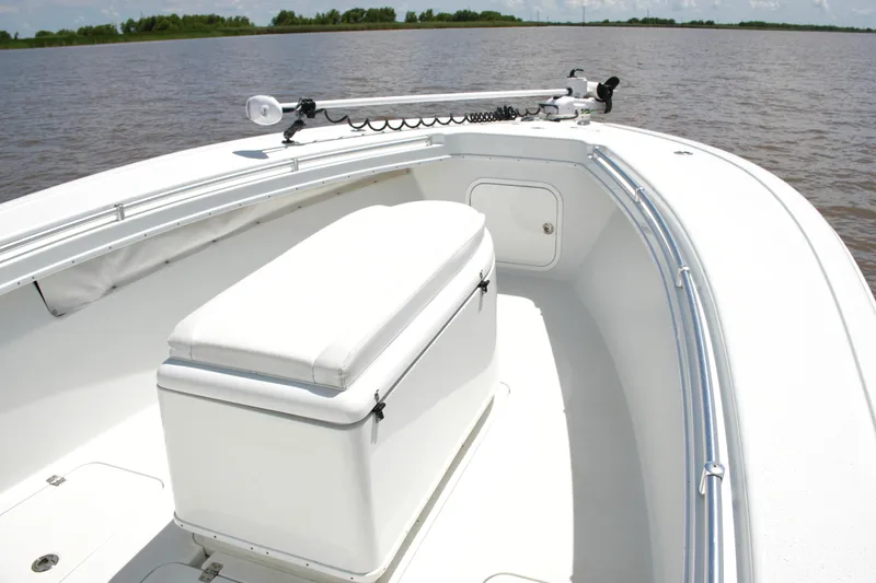 Slide: The Image of 2016 Yellowfin 32 Offshore boat interior with seating and storage, on calm water. - 20