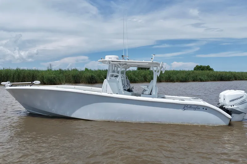 Slide: The Image of 2016 Yellowfin 32 Offshore boat on calm water with clear sky background. - 1