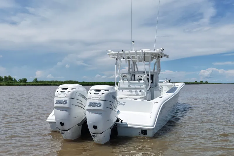 Slide: The Image of 2016 Yellowfin 32 Offshore boat with twin Mercury 350 engines on a calm waterway. - 14
