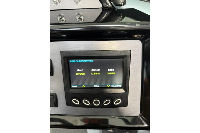 Slide: The Image of 2019 MasterCraft NXT22 dashboard displaying tab diagnostics with port, center, and starboard readings. - 30