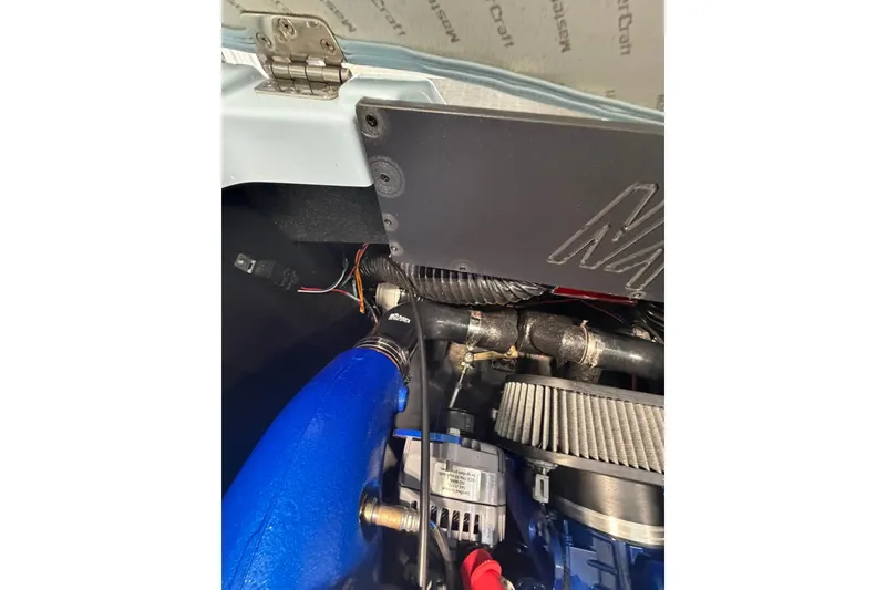 Slide: The Image of Engine compartment of a 2019 MasterCraft NXT22 boat, showcasing mechanical components. - 18
