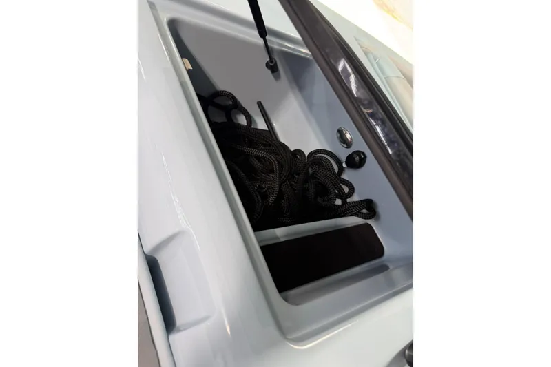 Slide: The Image of 2019 MasterCraft NXT22 storage compartment with black rope inside. - 32