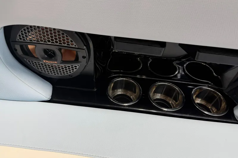 Slide: The Image of 2019 MasterCraft NXT22 boat interior with Klipsch speaker and stainless steel cup holders. - 25