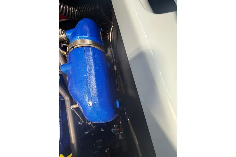 Slide: The Image of 2019 MasterCraft NXT22 engine compartment with blue engine component. - 21