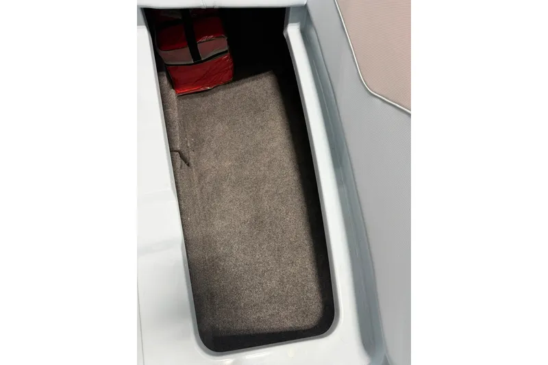 Slide: The Image of Storage compartment in 2019 MasterCraft NXT22 boat with red life jacket. - 34
