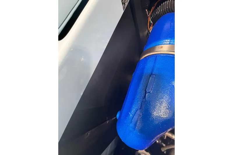 Slide: The Image of 2019 MasterCraft NXT22 engine detail with blue component and surrounding parts. - 17