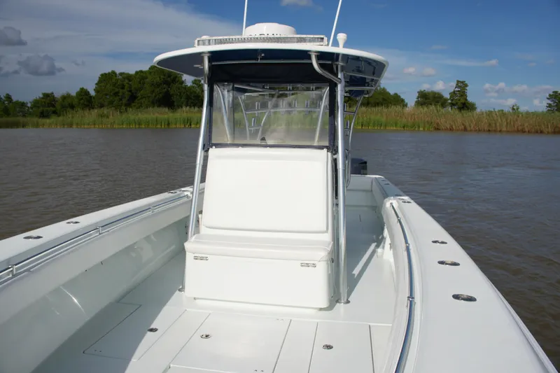 Slide: The Image of 2013 Contender 39 ST boat on calm water, featuring sleek design and spacious deck. - 24
