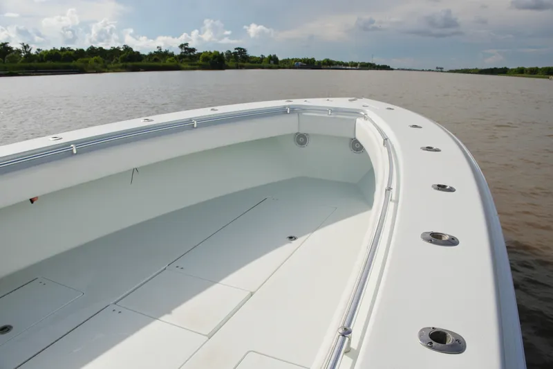 Slide: The Image of 2013 Contender 39 ST boat deck on calm river, clear sky background. - 23