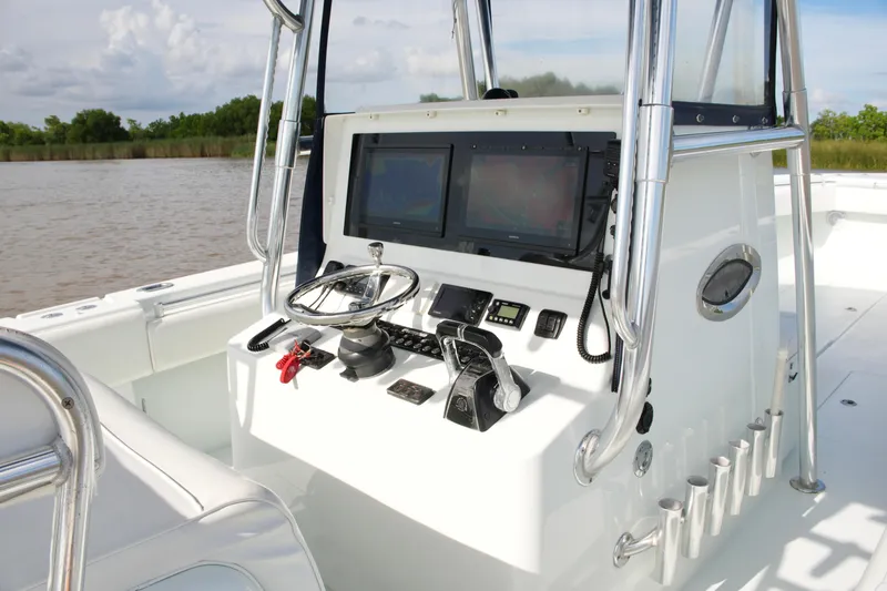 Slide: The Image of Center console of a 2013 Contender 39 ST boat with navigation equipment. - 31