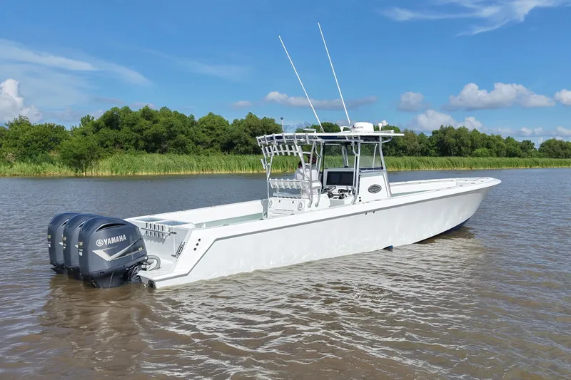 Slide: The Image of 2013 Contender 39 ST boat with Yamaha engines on a calm river. - 2