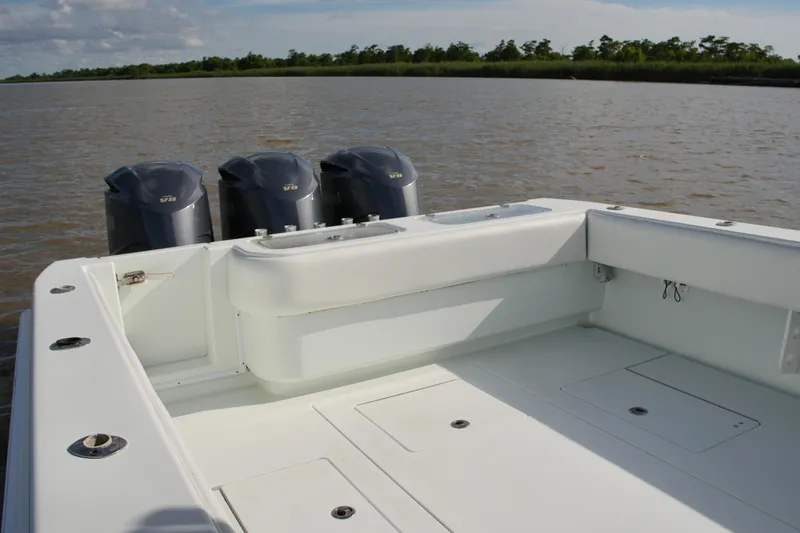 Slide: The Image of 2013 Contender 39 ST boat with triple outboard engines on calm water. - 20