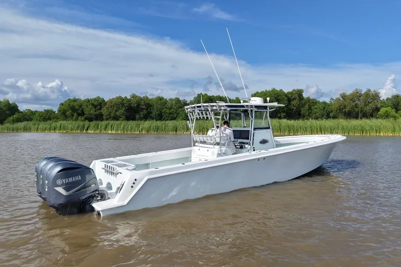 Slide: The Image of 2013 Contender 39 ST boat with Yamaha engines on a calm river. - 14