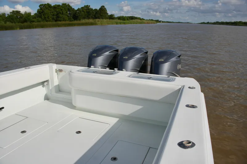 Slide: The Image of 2013 Contender 39 ST boat with triple outboard engines on a calm river. - 21