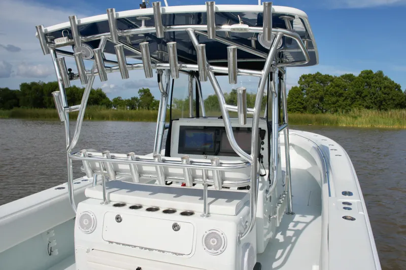 Slide: The Image of 2013 Contender 39 ST boat with rod holders and navigation equipment on a calm river. - 32