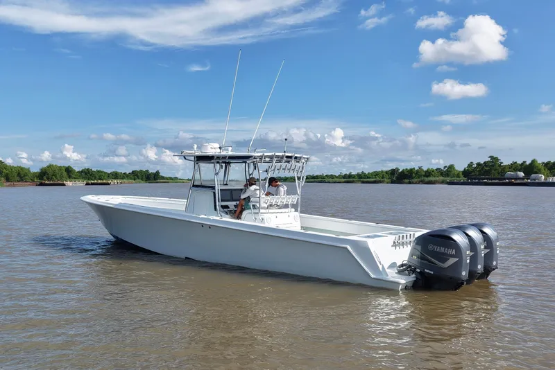 Slide: The Image of 2013 Contender 39 ST boat with Yamaha engines on a calm river. - 9
