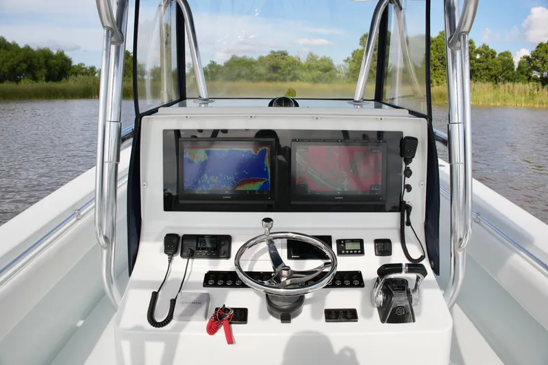 Slide: The Image of 2013 Contender 39 ST boat helm with dual navigation screens and controls. - 30