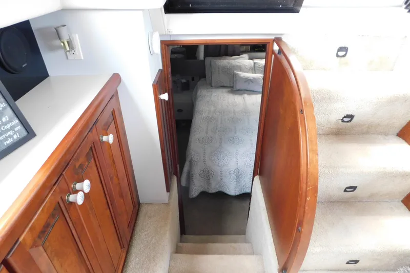 Slide: The Image of Interior view of 1992 Silverton 41 Aft Cabin, featuring stairs and cozy bedroom. - 97