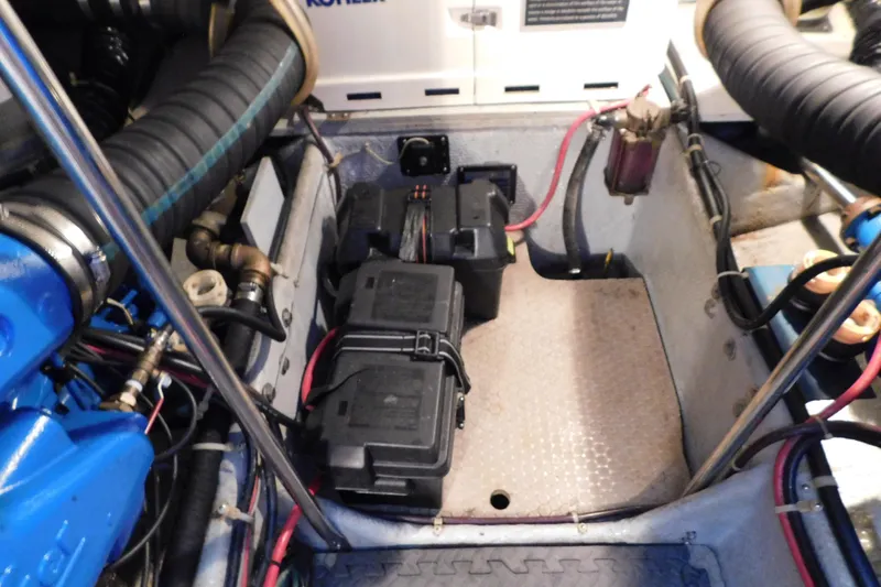 Slide: The Image of Engine compartment of a 1992 Silverton 41 Aft Cabin with visible batteries and wiring. - 96