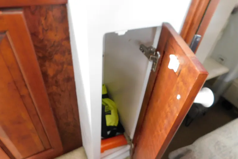 Slide: The Image of Open wooden cabinet door on 1992 Silverton 41 Aft Cabin boat interior. - 99